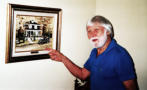 Ray and a picture of his parents' home in Attleboro, Mass.